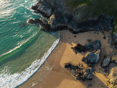 Beautiful aerial drone landscape image of Holywell Bay in Cornwall during vibrant Summer sunset