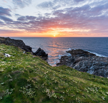Stunning Summer sunset landscape image of Pentire Headland in Cornwall England with dramatic skyの写真素材