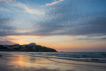 Stunning landscape travel image of Newquay beach in Cornwall during beautiful Summer sunsetの写真素材