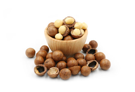 Close up Macadamia nuts  in wooden cup isolate on white  backgroundの写真素材