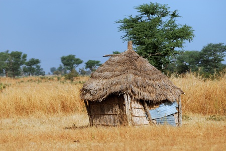 	 Cob cottage with thatched straw roof in African desert village, Africa.の写真素材
