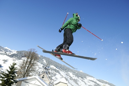 Jumping skier is having fun in mountain in winter