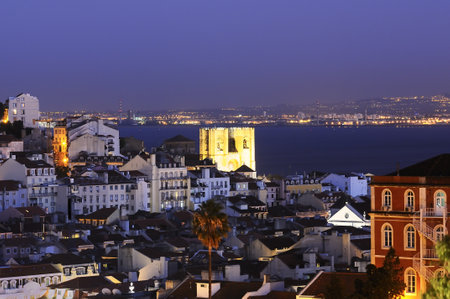 Historic mediterranean architecture with church at night with light in Lisboa, Portugalのeditorial素材