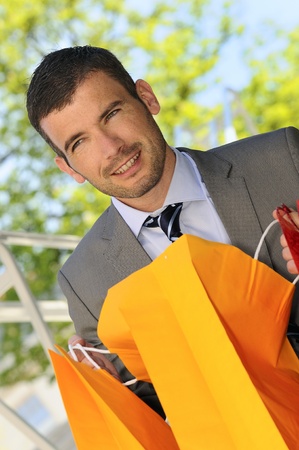 great businessman outdoor with colored shopping bagsの写真素材