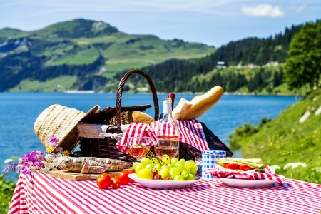 tasted picnic on the grass near a lakeの写真素材