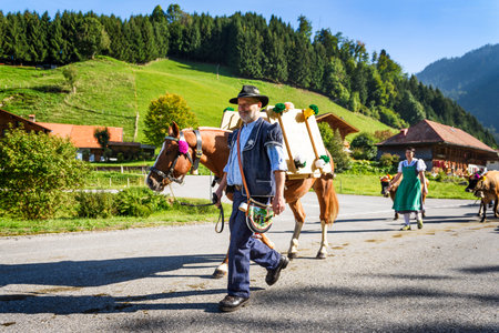 Charmey, Fribourg, Switzerland - 26 September 2015 : Farmers with a herd of cows on the annual transhumance at Charmey near Gruyeres, Fribourg zone on the Swiss alpsのeditorial素材