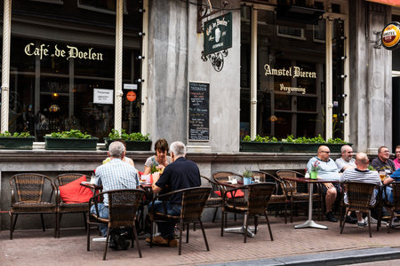 AMSTERDAM, NETHERLANDS, JULLY 9  2016.cafe de doelen in typical district of Amesterdam with people sitting on a terrace, NETHERLANDSのeditorial素材