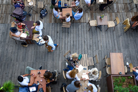 Paris, June 5, 2017 : people is havin lunch in a terrace restaurant, relaxing and friendly moment, style of life.のeditorial素材