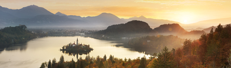Amazing View in autumn  : Bled Lake, Island,Church And Castle With Mountain Range (Stol, Vrtaca, Begunjscica) In The Background-Bled,Slovenia,Europeの写真素材