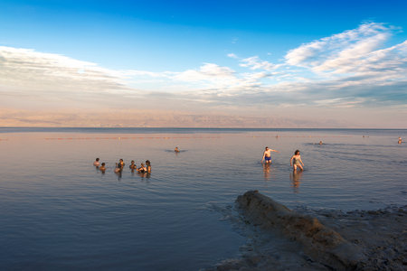 Dead Sea, Israel, May 05, 2017 : Photo of people  floating on surface Dead Sea enjoy summer sun and vacation. Recreation tourism, healthy lifestyle, free time conceptのeditorial素材