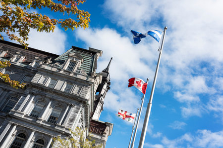 view of City Hall of old Montreal city with patriot flags by dayのeditorial素材