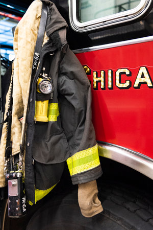 CHICAGO, ILLINOIS, USA - OCTOBER 10, 2018: The fireman's clothes by the real squad fire truck in Chicago Fire Department at the quarters of Engine Co. 5, filmed in the legendary series 'Chicago Fire' reportageのeditorial素材