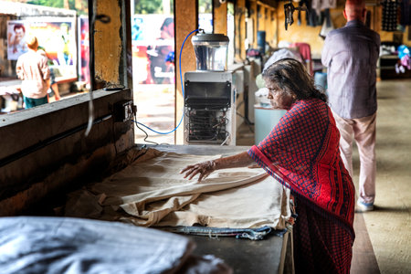 Cochin, kerala, India : December 25, 2018 : Old Indian woman is working in a traditionnal laundry in...