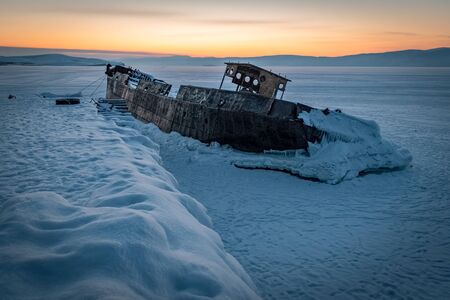 old abandoned boat in the port of Khoujir by winter, Baikal lake, Olkhon island, Siberia, Russia.の写真素材