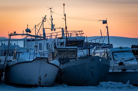 old abandoned boat in the port of Khoujir by winter, Baikal lake, Olkhon island, Siberia, Russia.の写真素材