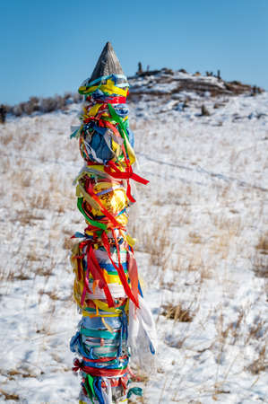 Sacred pillars with tied ribbons on Cape Burhan of Olkhon Island. Buryat traditions. Shamanistic and buddic rites of Lake Baikal. Olkhon Island, Baikal Lake, Buryatia republic Russiaの写真素材