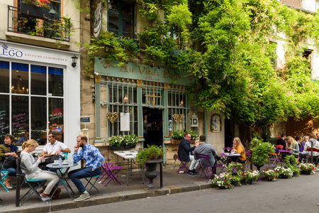 Paris, France, June 04, 2017: Famous style of life in Paris, France with bistrrots and people on terraces. Here, this is "The old Paris" traditional bistrot on the Ile de la Cite in spring time, near Notre dame, Paris, France.のeditorial素材