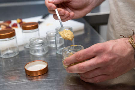 hands of a man is manufacturing food in a kitchen