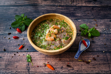 Vietnamese specialty: ravioli soup in a bowl and placed on a wooden table