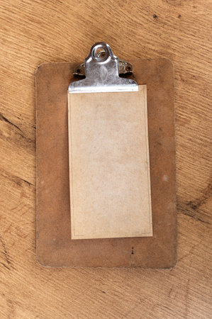 Paper note fixed with a clip on a wooden shelfの写真素材