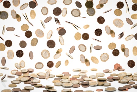 Heap of euro coins falling to the ground, white backgroundの写真素材