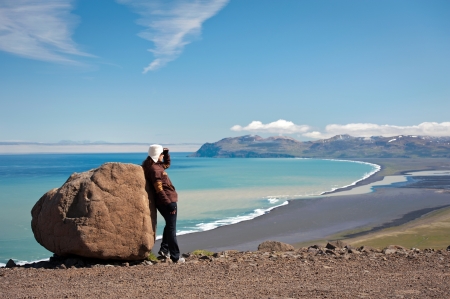 young woman looking at amazing Icelandic landscapeの写真素材
