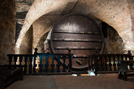 Vintage giant wine barrel in a cellarの写真素材