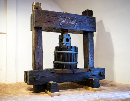 Traditional old technique of wine making, wooden antique grape pressの写真素材