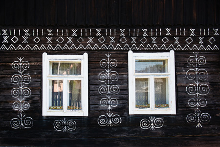 Unique decoration of log houses based on patterns used in traditional embroidery in village of Cicmany, UNESCO World Heritage Site, Slovakiaのeditorial素材