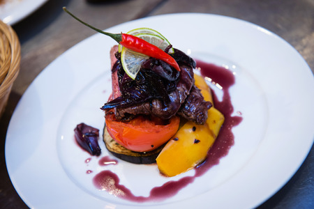 Delicious stewed steak with grilled vegetables and red onion sauceの写真素材
