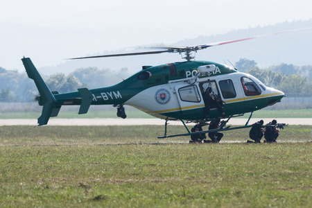 SLIAC, SLOVAKIA - AUGUST 30: Dynamic display of police commando attack from Bell 429 helicopter at SIAF airshow in Sliac, Slovakia on August 30, 2015のeditorial素材