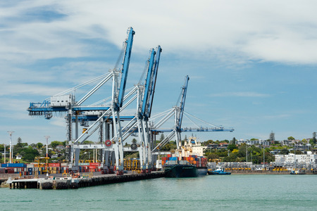AUCKLAND, NEW ZEALAND - NOV 8, 2015: Cargo ship and container cranes on Fergusson Wharf at Ports of Auckland. It is New Zealand's largest commercial portのeditorial素材