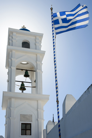 Bell tower with Greek flag in Imerovigli, Santorini, Greeceの写真素材