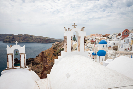 Belfry with blue domes of churches in Oia, Santorini, Greeceの写真素材