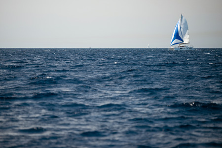 Catamaran sailing on open seaの写真素材