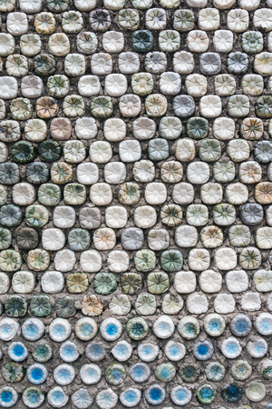 Bottle recycling: plastic bottles which have been set in concrete to form a bottle wallの写真素材