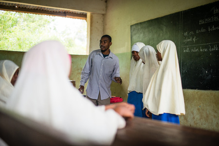 KENDWA, ZANZIBAR - JAN 10, 2018: Teacher with students during English lesson, Primary school at Kendwa, Zanzibarのeditorial素材