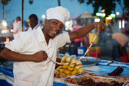 STONE TOWN, ZANZIBAR - DEC 31, 2017: Man selling street food at Forodhani Garden in Stone Town, Zanzibarのeditorial素材