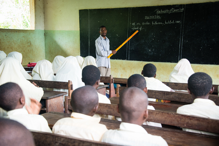 KENDWA, ZANZIBAR - JAN 10, 2018: Teacher and students in a classroom during English lesson, Primary school at Kendwa, Zanzibarのeditorial素材