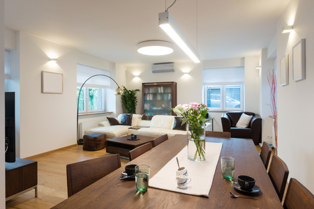 Dining table next to kitchen in modern houseの写真素材