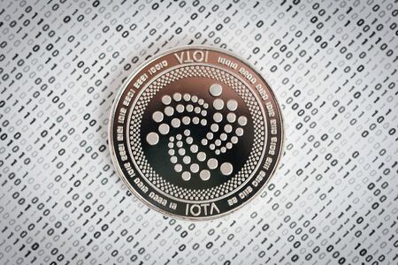 Crypto currency coin - IOTA on binary backgroundの写真素材