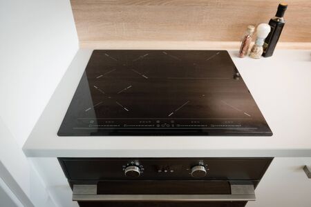 Electric stove with induction cooktop in contemporary kitchenの写真素材
