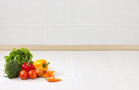 Empty space on the counter in the kitchen with vegetables for putting text or your product on itの写真素材