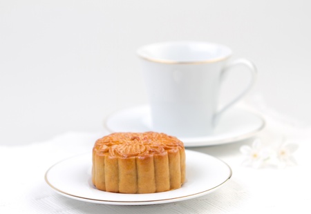Moon cake served with tea, traditional dessert for the Chinese mid autumn festival