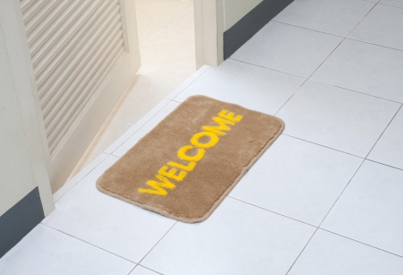 Welcome doormat in front of the rest roomの写真素材