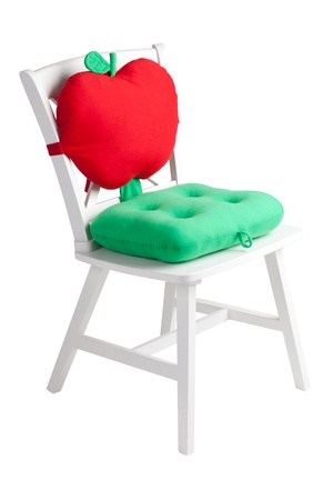 A wooden white chair with a cute cushion and padの写真素材