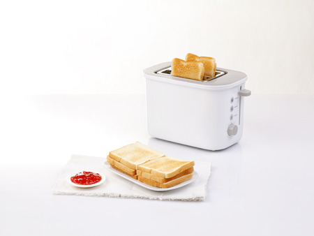bread toaster and toasted bread served with jam