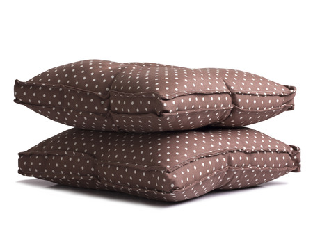 Polka dot brown cushions isolated on white backgroundの写真素材