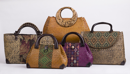 Set of beautiful wicker women handbags isolated on white background