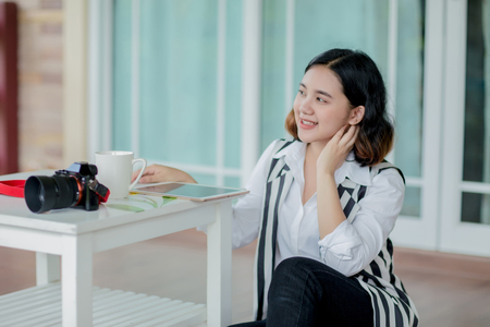 Young asian woman sitting on the floor and relaxing on the day timeの写真素材